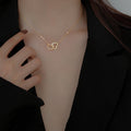 Doppelherz Halskette – Verschlungene Herzen | Gold & Silber